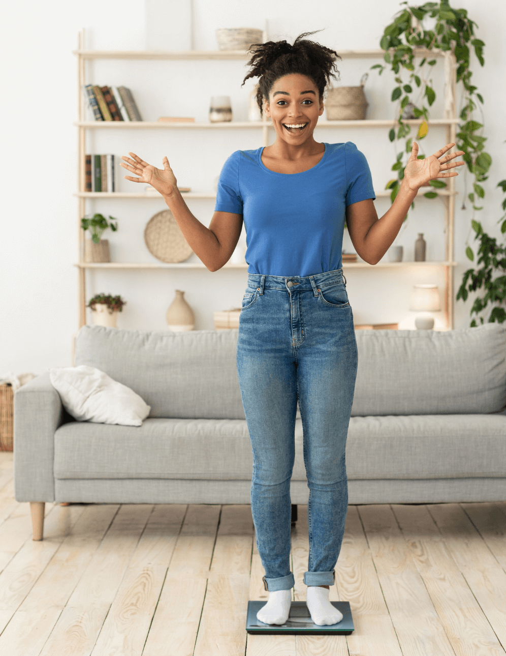 Woman celebrating on scale in living room