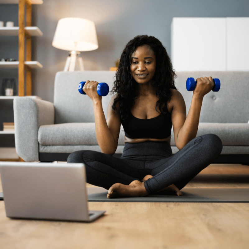 Woman using small hand weights for a simple, sustainable at-home workout