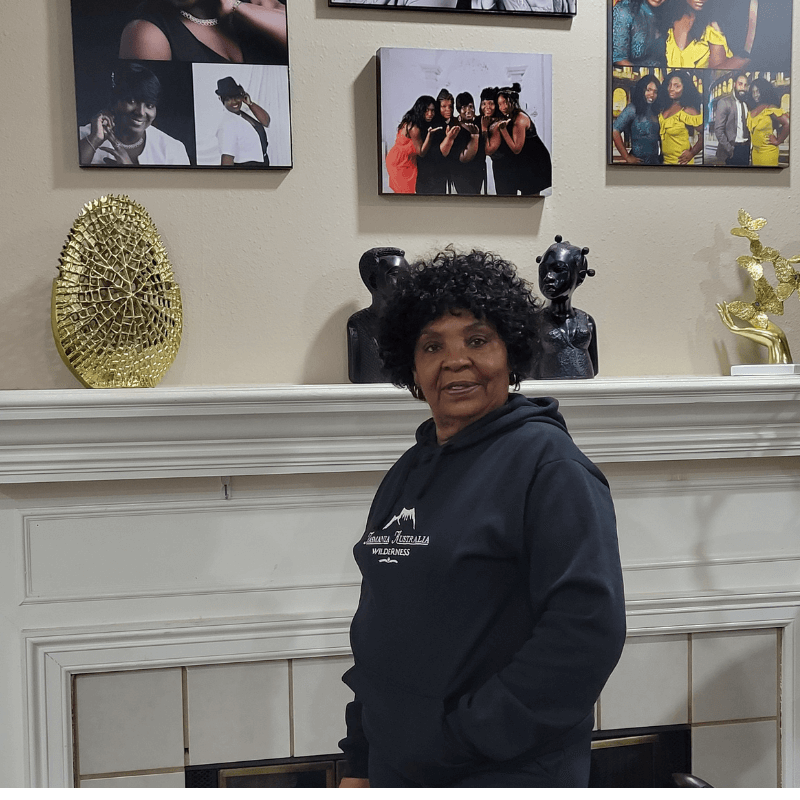 Confident midlife woman standing indoors, smiling and looking healthy