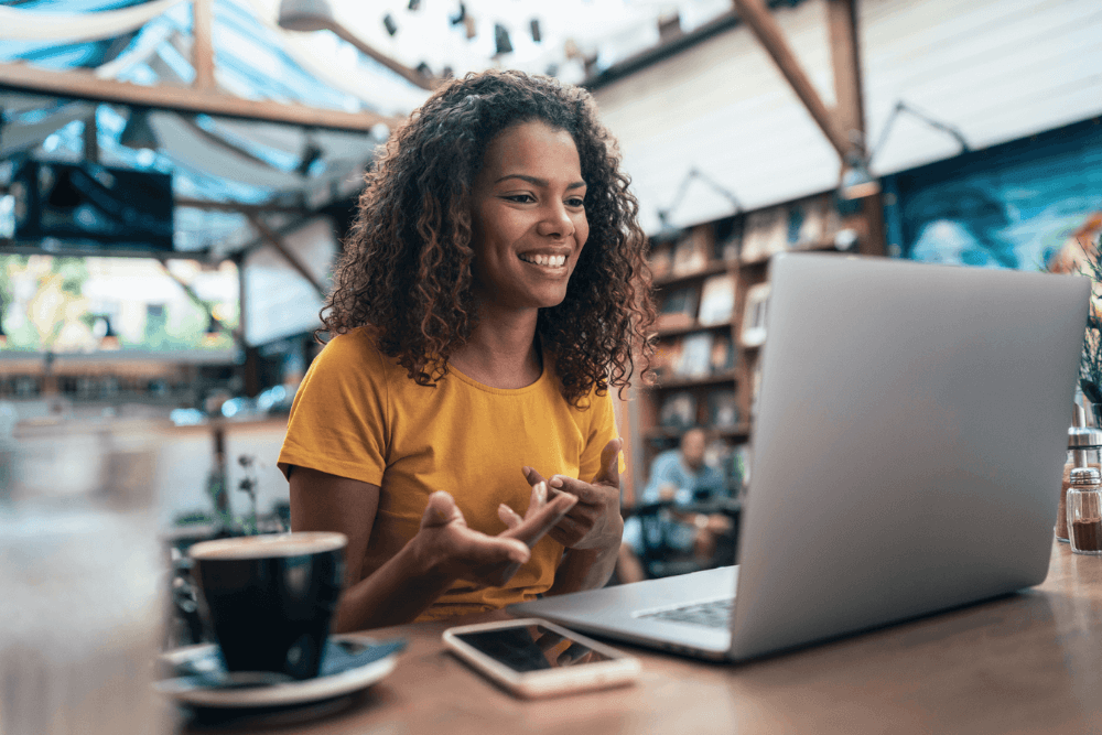 Woman using a laptop in a bright indoor space